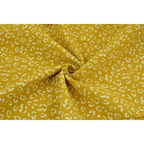 Double gauze 100% cotton white speckles on a mustard background
