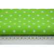 Cotton 100% white 2mm polka dots on a bright green background