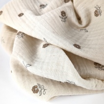 Organic cotton muslin with flowers on a natural background