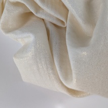 Double gauze 100% cotton shiny, golden particles on a cream background