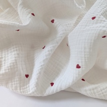 Double gauze 100% cotton, red hearts on a cream background