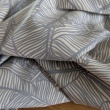 100% cotton, grey leaves on a cream background