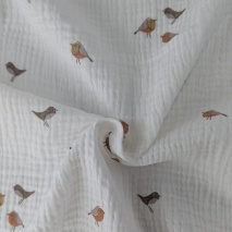 Cotton muslin, caramel birds on a cream background