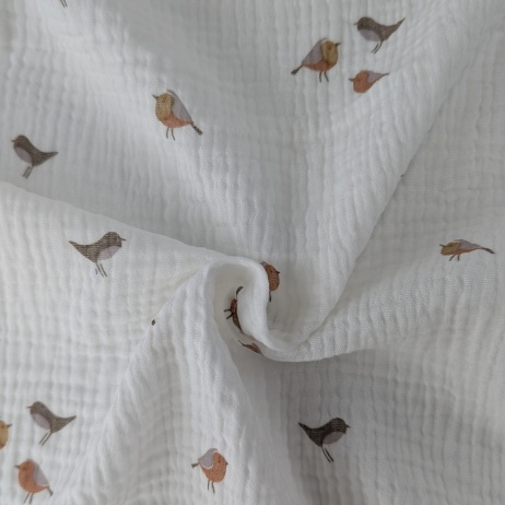 Cotton muslin, caramel birds on a cream background