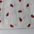 Double gauze 100% cotton, ladybugs on a cream background