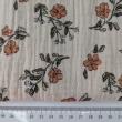 Cotton muslin with orange and blue flowers on a beige background