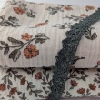 Cotton muslin with orange and blue flowers on a beige background