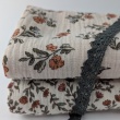 Double gauze 100% cotton, small orange flowers on a beige background