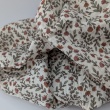 Double gauze 100% cotton, small orange flowers on a beige background