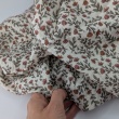 Double gauze 100% cotton, small orange flowers on a beige background