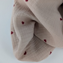 Double gauze 100% cotton, red hearts on a beige background