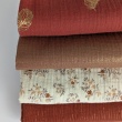 Double gauze 100% cotton shiny, golden particles on a caramel background