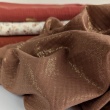 Double gauze 100% cotton shiny, golden particles on a caramel background