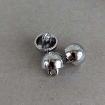 Silver metal button, 1 cm in diameter.