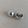Silver metal button, 1 cm in diameter.