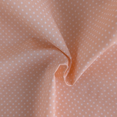 Cotton 100% white 2mm polka dots on a light orange background