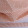Cotton 100% white 2mm polka dots on a light orange background