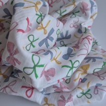 Cotton muslin, colorful bows on a white background