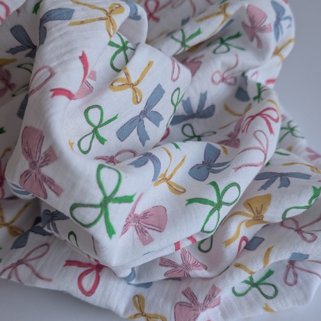 Cotton muslin, colorful bows on a white background