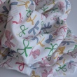 Cotton muslin, colorful bows on a white background