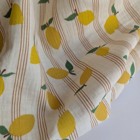 Cotton muslin, lemons on a vanilla background