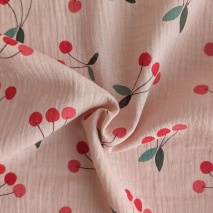 Cotton muslin, cherries on a pink-beige background