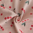 Cotton muslin, cherries on a pink-beige background