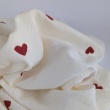 Cotton muslin with embroidered red hearts on an ecru background