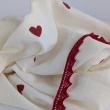 Cotton muslin with embroidered red hearts on an ecru background