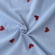 Cotton muslin with embroidered red hearts on a blue background
