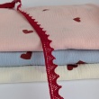 Cotton muslin with embroidered red hearts on a blue background