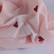 Cotton muslin with embroidered red hearts on a pink background