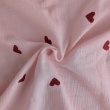 Cotton muslin with embroidered red hearts on a pink background