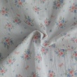 Organic cotton muslin, bows, bouquets on an ecru background