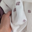 Cotton muslin, embroidered, heather flowers on an ecru background