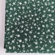 Cotton 100% white meadow on a dark green background, small flowers