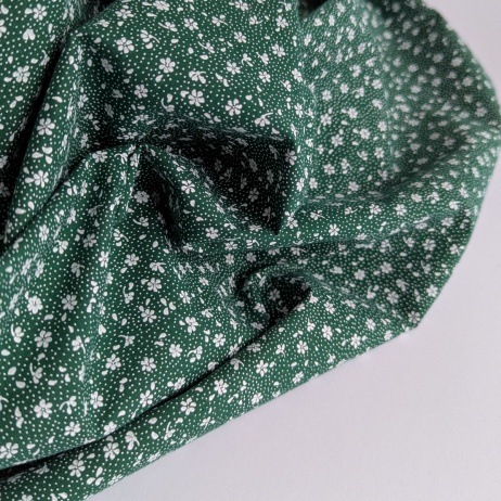 Cotton 100% white meadow on a dark green background, small flowers