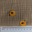 Cotton muslin, embroidered sunflowers on a beige background