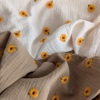Cotton muslin, embroidered sunflowers on a beige background