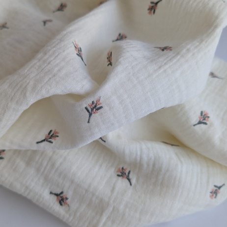 Cotton muslin, embroidered, salmon flowers, twigs on a cream background