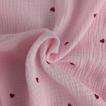 Double gauze 100% cotton, red hearts on a light pink background