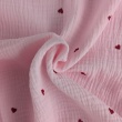 Double gauze 100% cotton, red hearts on a light pink background
